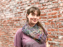 Load image into Gallery viewer, Fossil Cowl in rainbow shown on a model wearing a purple shirt against a brick wall
