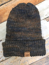 Load image into Gallery viewer, The Hadrosaur Hat is a lightweight, double layered slouchy beanie with folded brim.  It is shown here in blue/brown in a flat lay.
