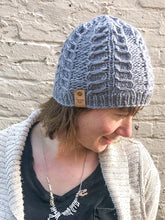 Load image into Gallery viewer, Fossil Beanie in gray without pom.  It is shown here on a model.
