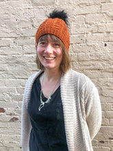 Load image into Gallery viewer, Fossil Beanie in copper with black pom.  It is shown here on a model.
