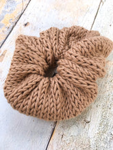 Load image into Gallery viewer, The Cotton Scrunchy is a simple knit hair accessory. It is show here in sand (light brown) in a flat lay.
