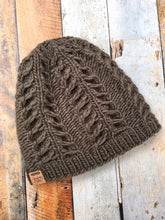 Load image into Gallery viewer, Fossil Beanie in olive without pom.  It is shown here in a flat lay.
