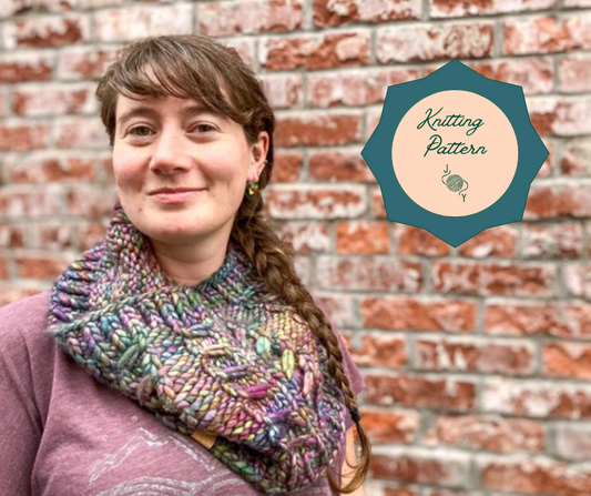 Rainbow Fossil Cowl with cabled pattern in bulky shown on a model with a circle that says "knitting pattern".