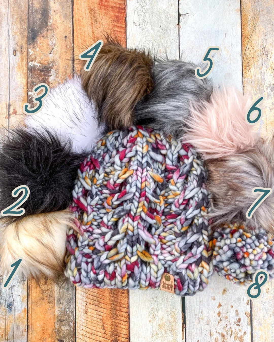 Fossil Beanie in gray with speckled orange and purple shown in a flat lay with all 8 pom options.