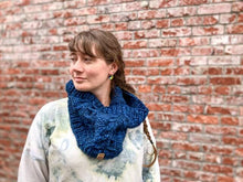 Load image into Gallery viewer, Fossil Cowl in blue shown on a model wearing a white sweatshirt against a brick wall

