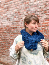 Load image into Gallery viewer, Fossil Cowl in blue shown on a model wearing a white sweatshirt against a brick wall
