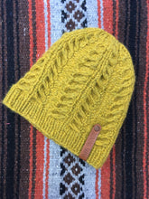 Load image into Gallery viewer, The Fossil Beanie is shown here in bulky weight yarn in a mustard color in a flat lay.
