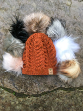 Load image into Gallery viewer, Fossil Beanie in copper in a flat lay with all 7 faux fur poms arranged around it&#39;s top.
