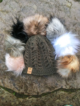 Load image into Gallery viewer, Fossil Beanie in olive in a flat lay with all 7 faux fur poms arranged around it&#39;s top.
