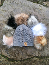 Load image into Gallery viewer, Fossil Beanie in olive in a flat lay with all 7 faux fur poms arranged around it&#39;s top.
