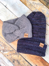 Load image into Gallery viewer, A folded brim beanie and knotted headwrap in flat lay.  The beanie is made with blue tones, and the wrap is made with gray tones.
