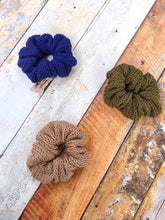 Load image into Gallery viewer, Three scruchies in a flat lay arranged in a triangle.  They are navy, light brown (sand), and olive.
